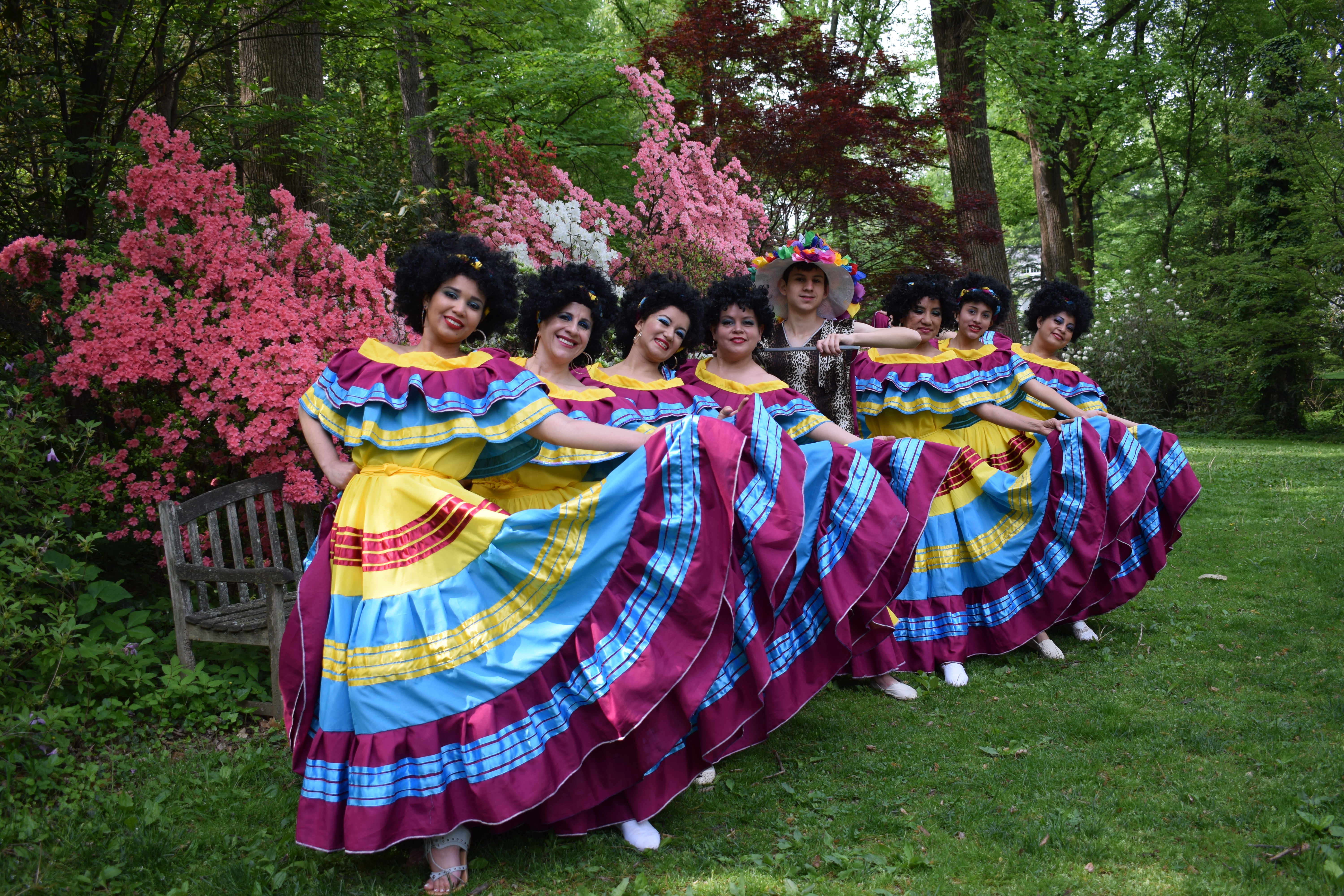 Dance group in traditional Colombian costumes performing at a corporate event