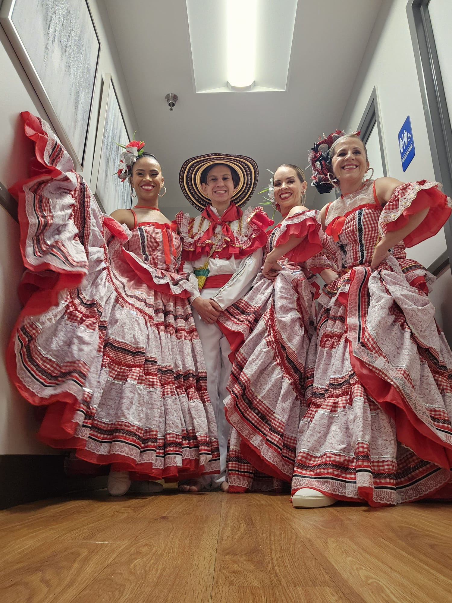 Four female dancers in red dresses